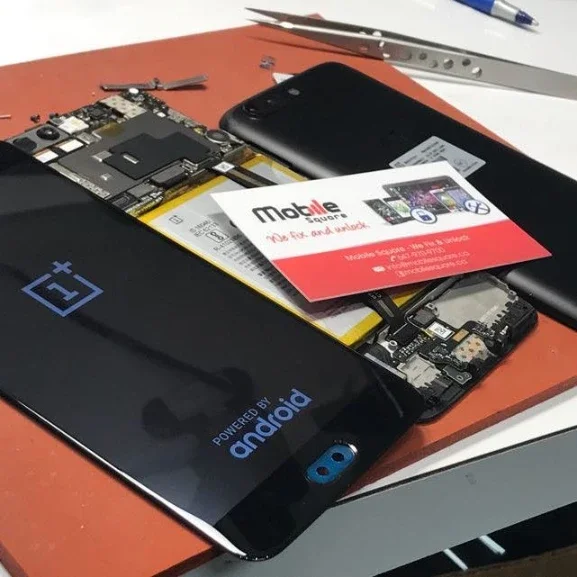 OnePlus phone disassembled with internal parts for repair